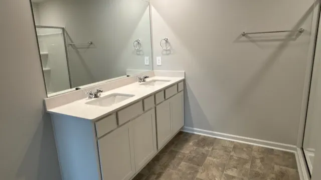 a utility room with a sink and a mirror