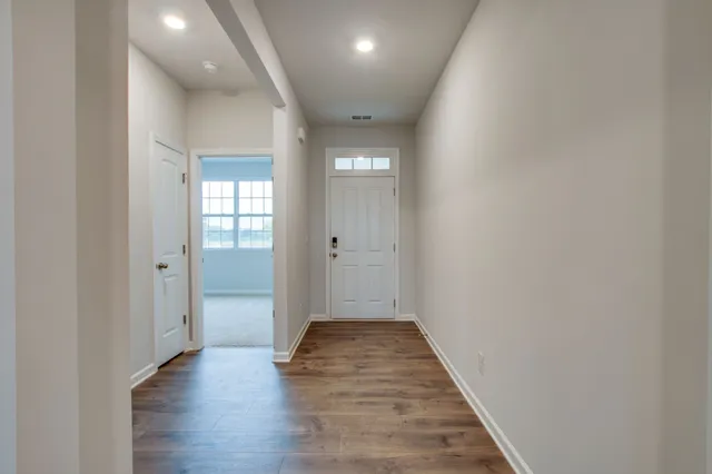 a view of a hallway with wooden floor