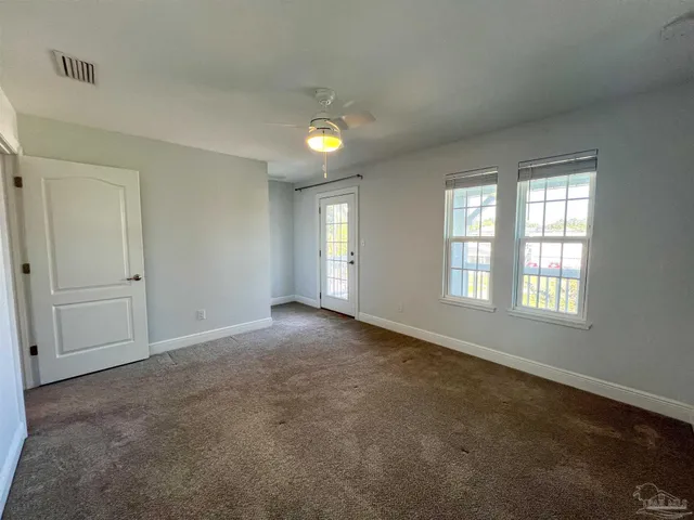 an empty room with windows and closet