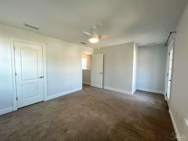 a view of an empty room and closet area