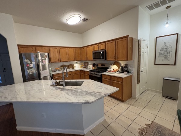 432 Hanover Court Georgetown, TX 78633 - Photo 3 of 14 a kitchen with stainless steel appliances granite countertop a stove a sink a refrigerator and a refrigerator