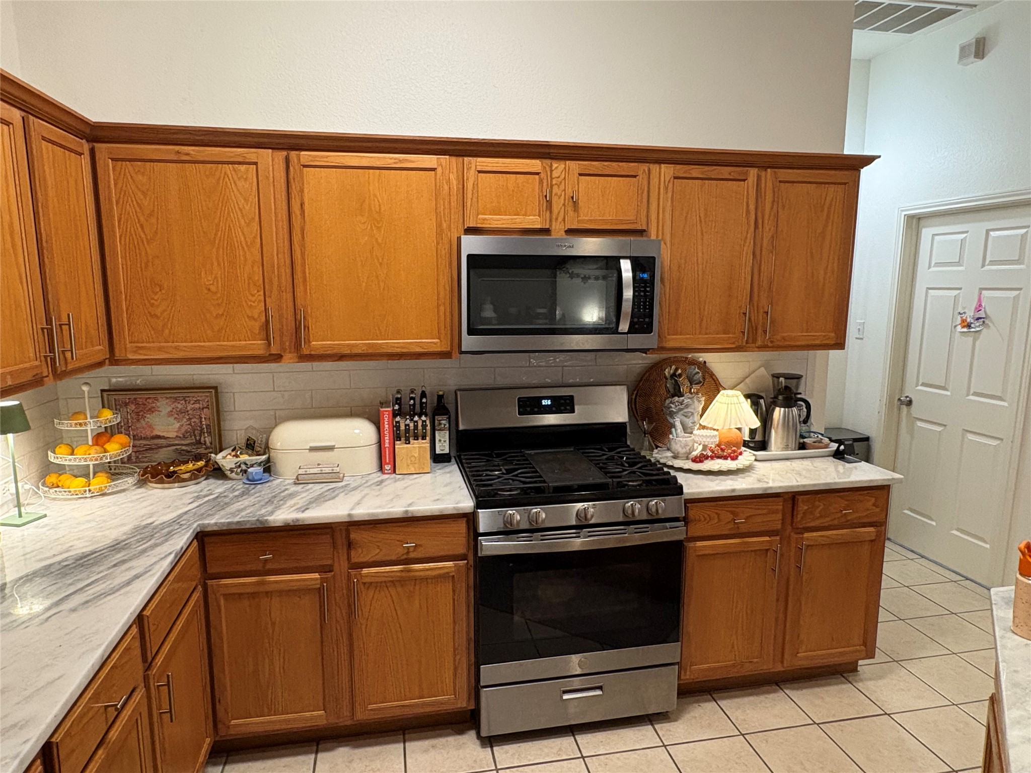 432 Hanover Court Georgetown, TX 78633 - Photo 4 of 14 a kitchen with stainless steel appliances a stove a sink and a microwave