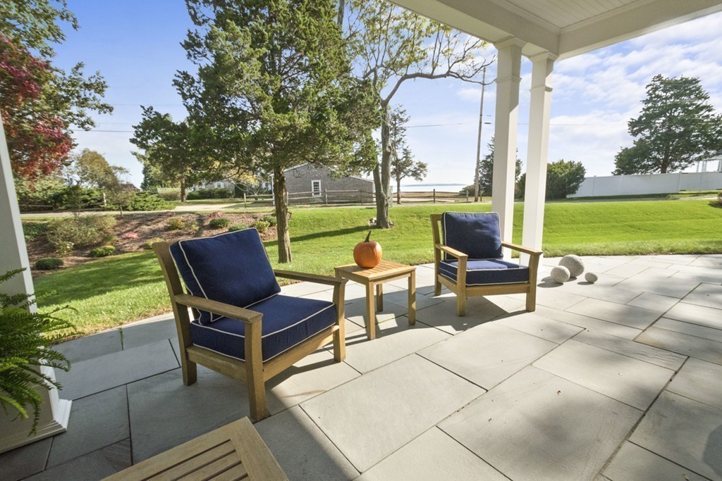 282 King Caesar Road Duxbury, MA 02332 - Photo 9 of 30 a view of a patio with a table chairs and a yard