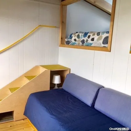 a bedroom with a bed and painting on the wall