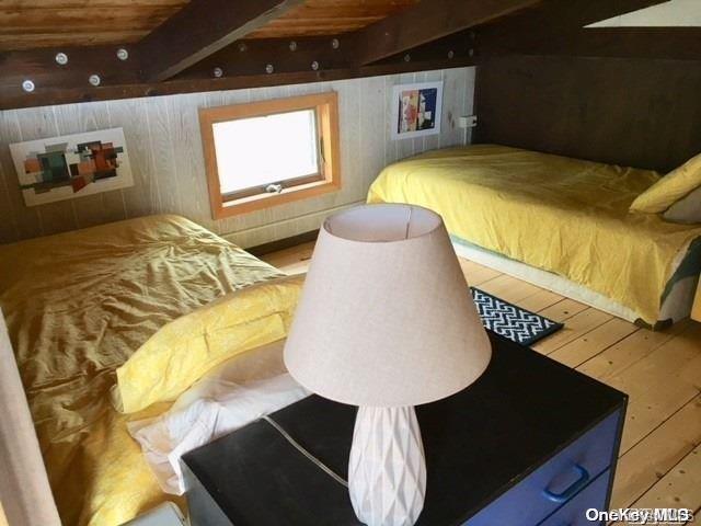 190 Clipper Ocean Beach, NY 11770 - Photo 15 of 21 a bedroom with a bed and a chandelier