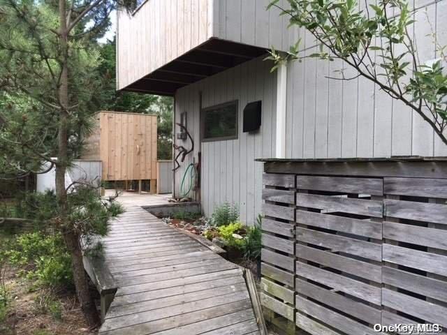 190 Clipper Ocean Beach, NY 11770 - Photo 18 of 21 a backyard of a house with potted plants and large tree