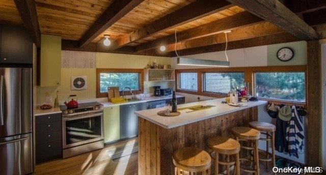 190 Clipper Ocean Beach, NY 11770 - Photo 6 of 21 a room with stainless steel appliances kitchen island granite countertop a table chairs and a refrigerator