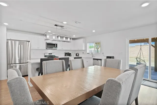 a large kitchen with cabinets table and chairs