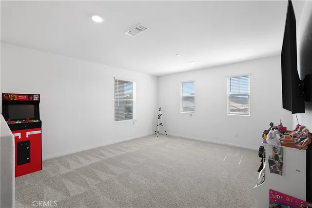 a view of a livingroom with furniture and a flat screen tv