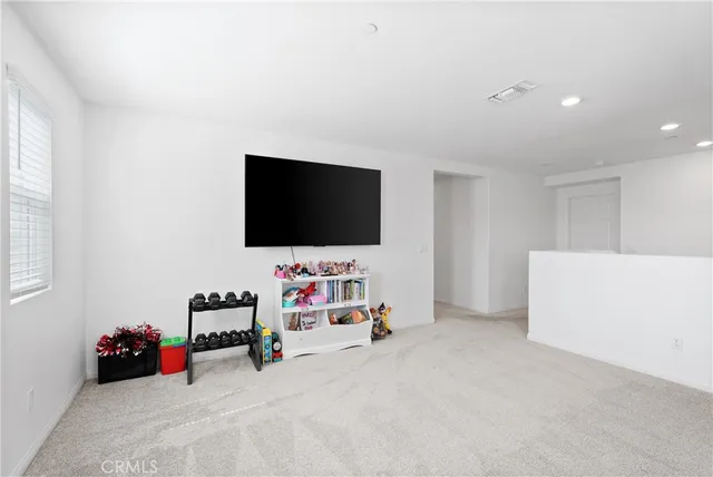 a view of a livingroom with furniture and a flat screen tv