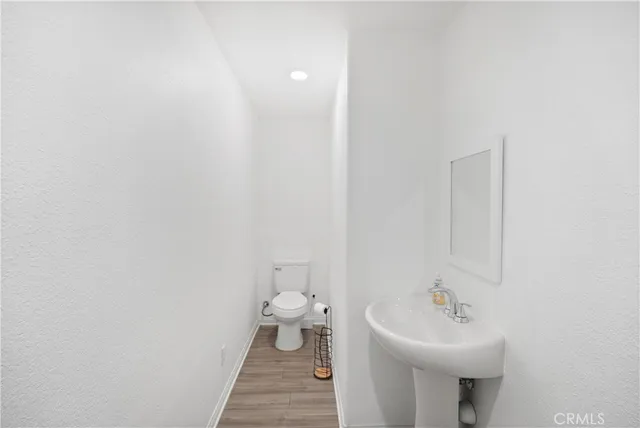 a bathroom with a sink a toilet and mirror