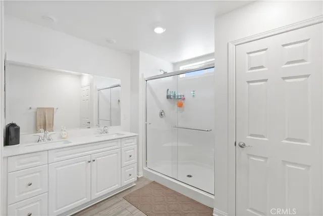 a spacious bathroom with a shower sink and mirror
