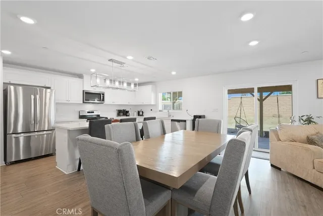 a large kitchen with a table and chairs