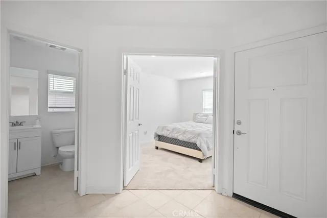 a en suite bathroom with a toilet sink and a mirror