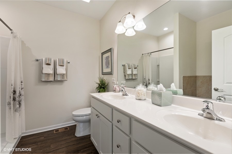 1004 Lexington Street McHenry, IL 60050 - Photo 12 of 20 a bathroom with a double vanity sink mirror and toilet