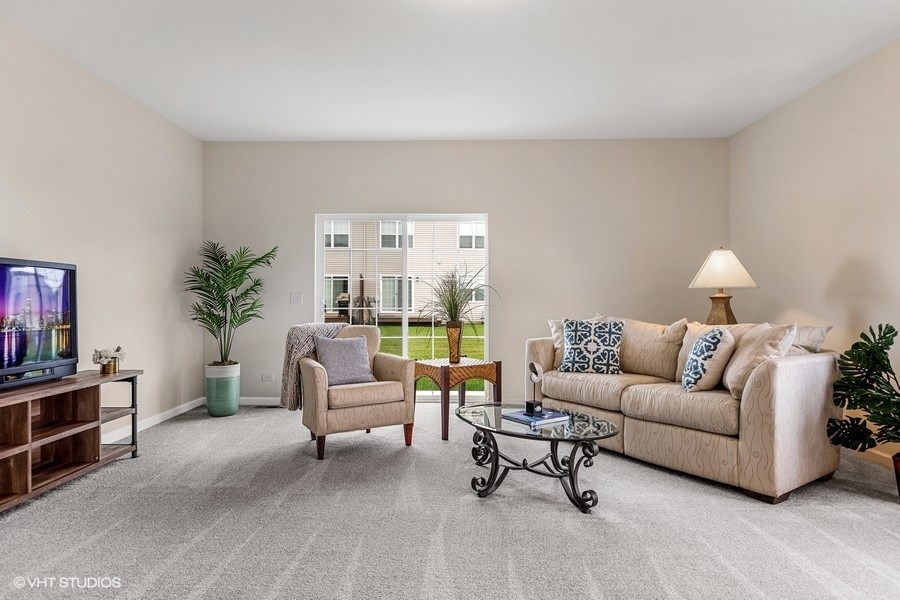 1004 Lexington Street McHenry, IL 60050 - Photo 5 of 20 a living room with furniture and a large window