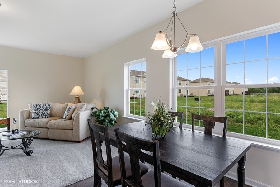 1004 Lexington Street McHenry, IL 60050 - Photo 6 of 20 a living room with furniture a window and a dining table