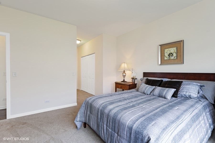 1004 Lexington Street McHenry, IL 60050 - Photo 10 of 20 a bedroom with a bed and painting on the wall
