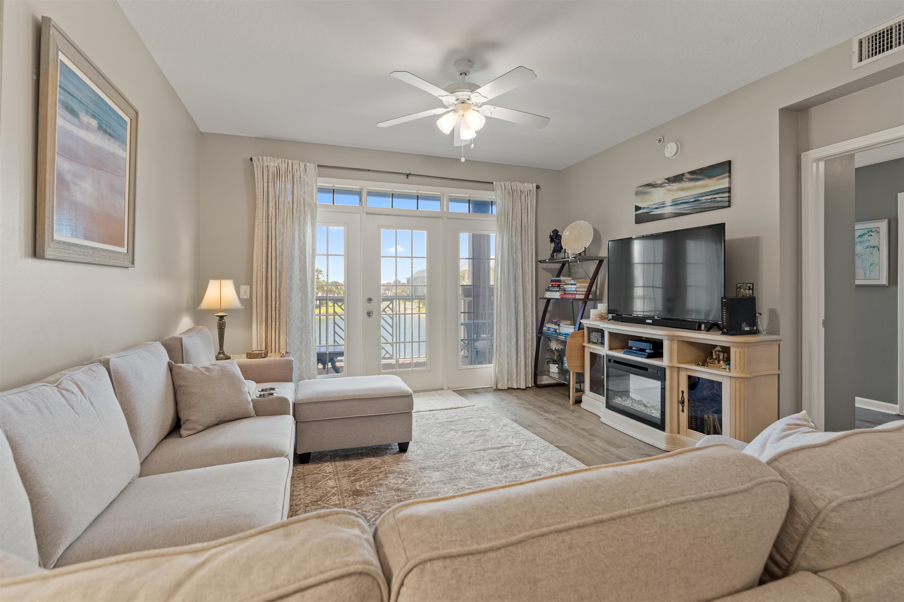 255 Atlantis Circle, Unit D202 St. Augustine Beach, FL 32080 - Photo 14 of 45 a living room with furniture and a flat screen tv