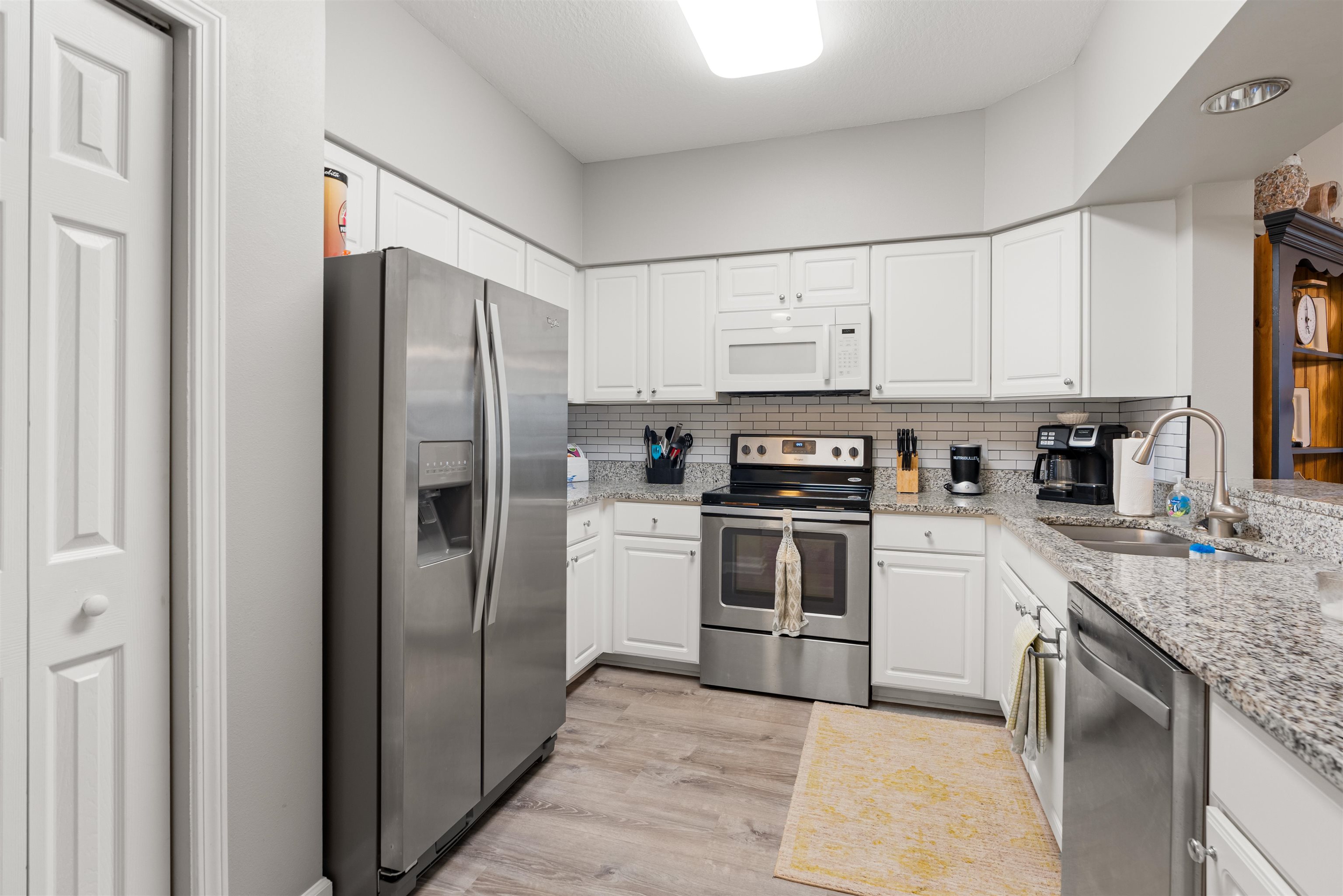 255 Atlantis Circle, Unit D202 St. Augustine Beach, FL 32080 - Photo 16 of 45 a kitchen with stainless steel appliances granite countertop a refrigerator stove and sink
