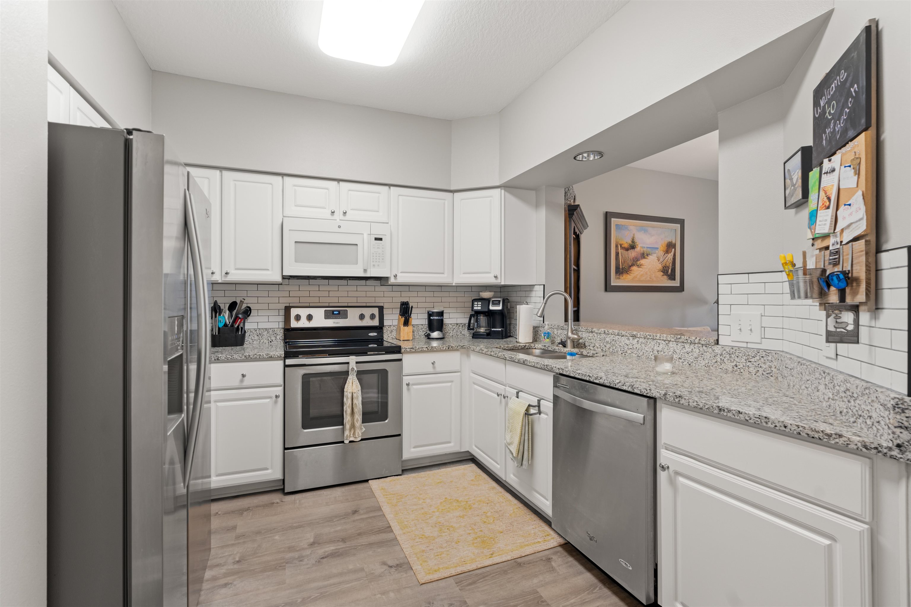 255 Atlantis Circle, Unit D202 St. Augustine Beach, FL 32080 - Photo 17 of 45 a kitchen with stainless steel appliances granite countertop a refrigerator and a stove top oven