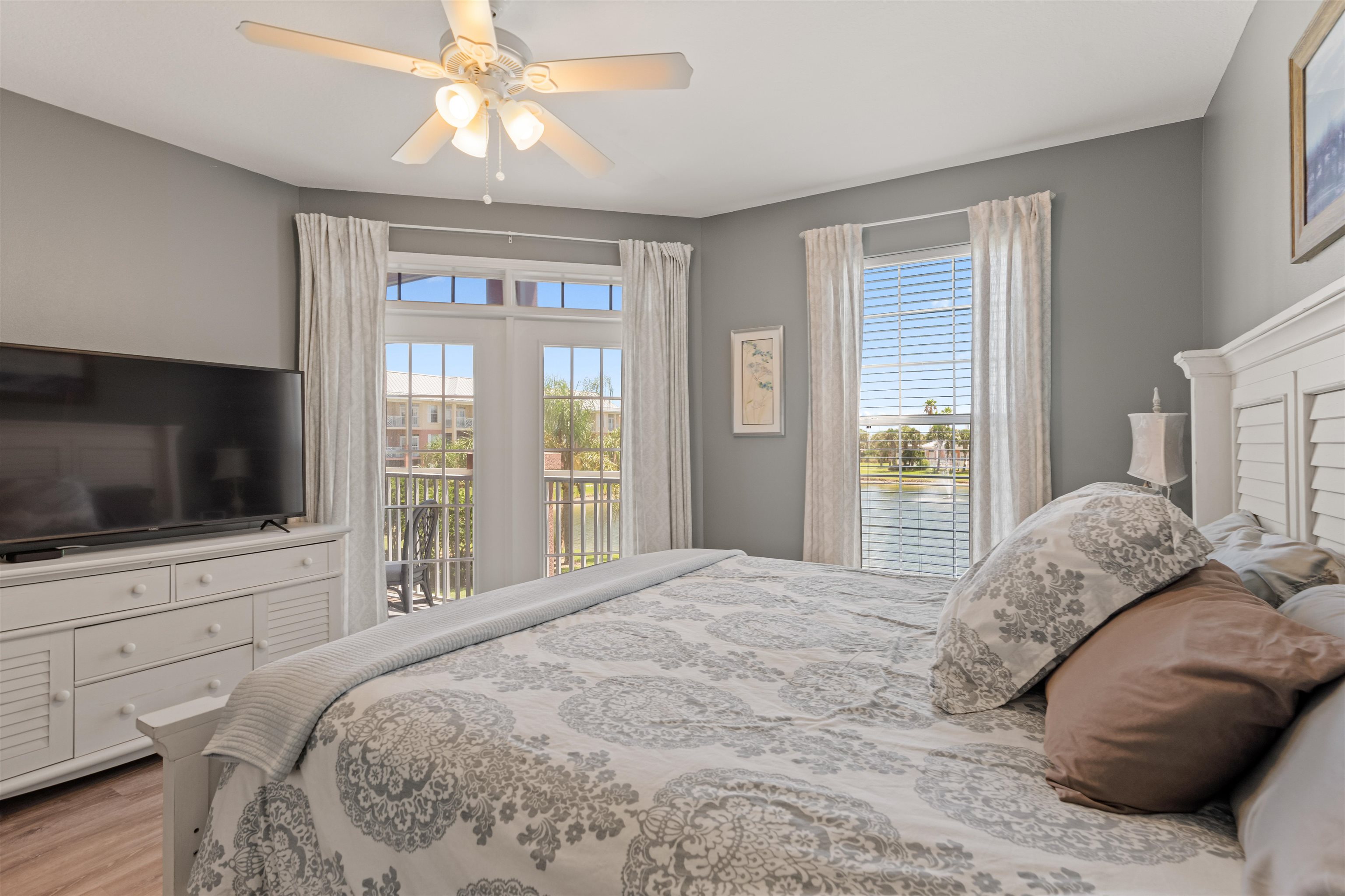 255 Atlantis Circle, Unit D202 St. Augustine Beach, FL 32080 - Photo 25 of 45 a bedroom with a large bed and a flat screen tv