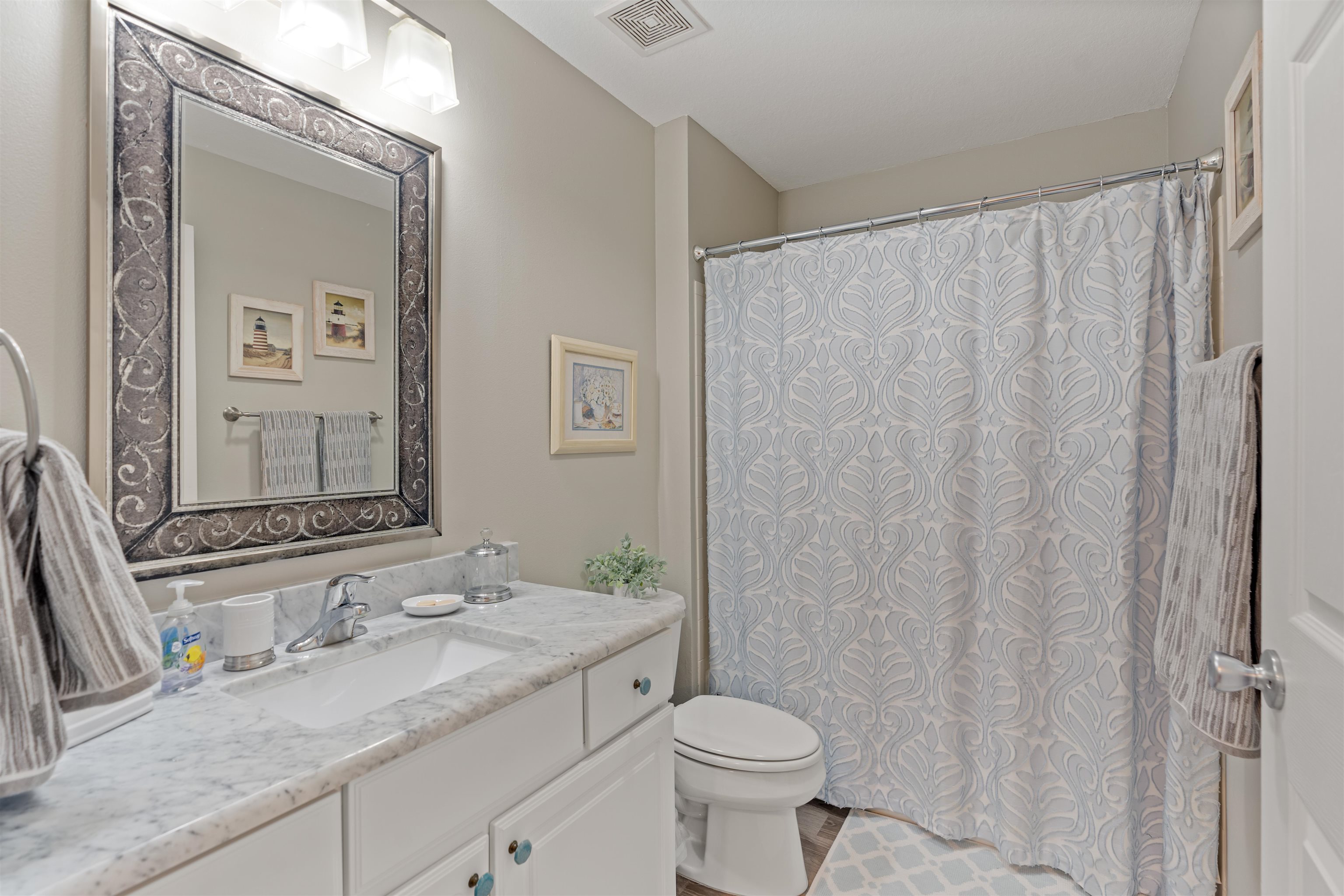 255 Atlantis Circle, Unit D202 St. Augustine Beach, FL 32080 - Photo 26 of 45 a bathroom with a granite countertop sink and a mirror