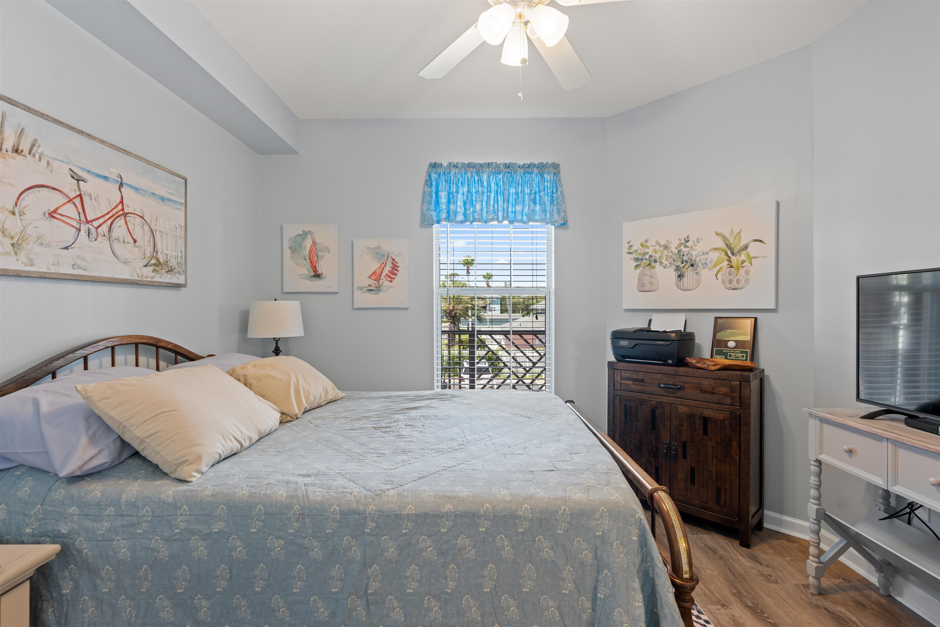 255 Atlantis Circle, Unit D202 St. Augustine Beach, FL 32080 - Photo 28 of 45 a bedroom with a large bed and a flat tv screen on dresser