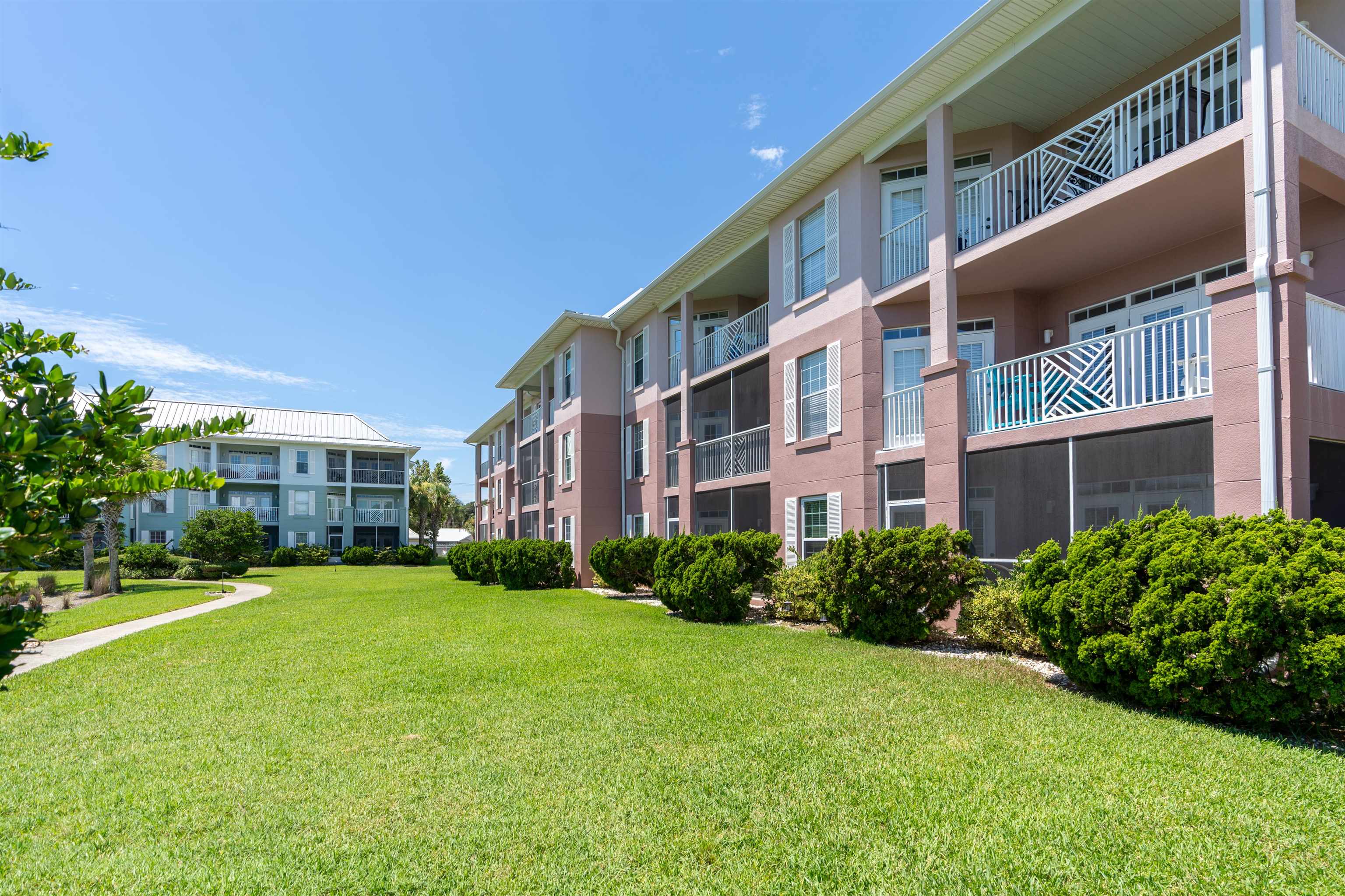 255 Atlantis Circle, Unit D202 St. Augustine Beach, FL 32080 - Photo 33 of 45 a view of a building with a yard