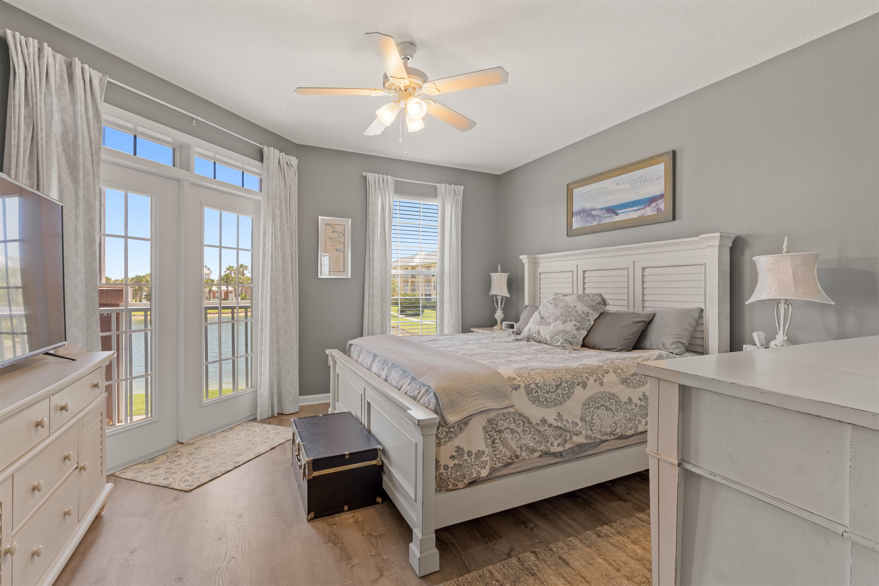 255 Atlantis Circle, Unit D202 St. Augustine Beach, FL 32080 - Photo 4 of 45 a bedroom with a large bed and a chandelier