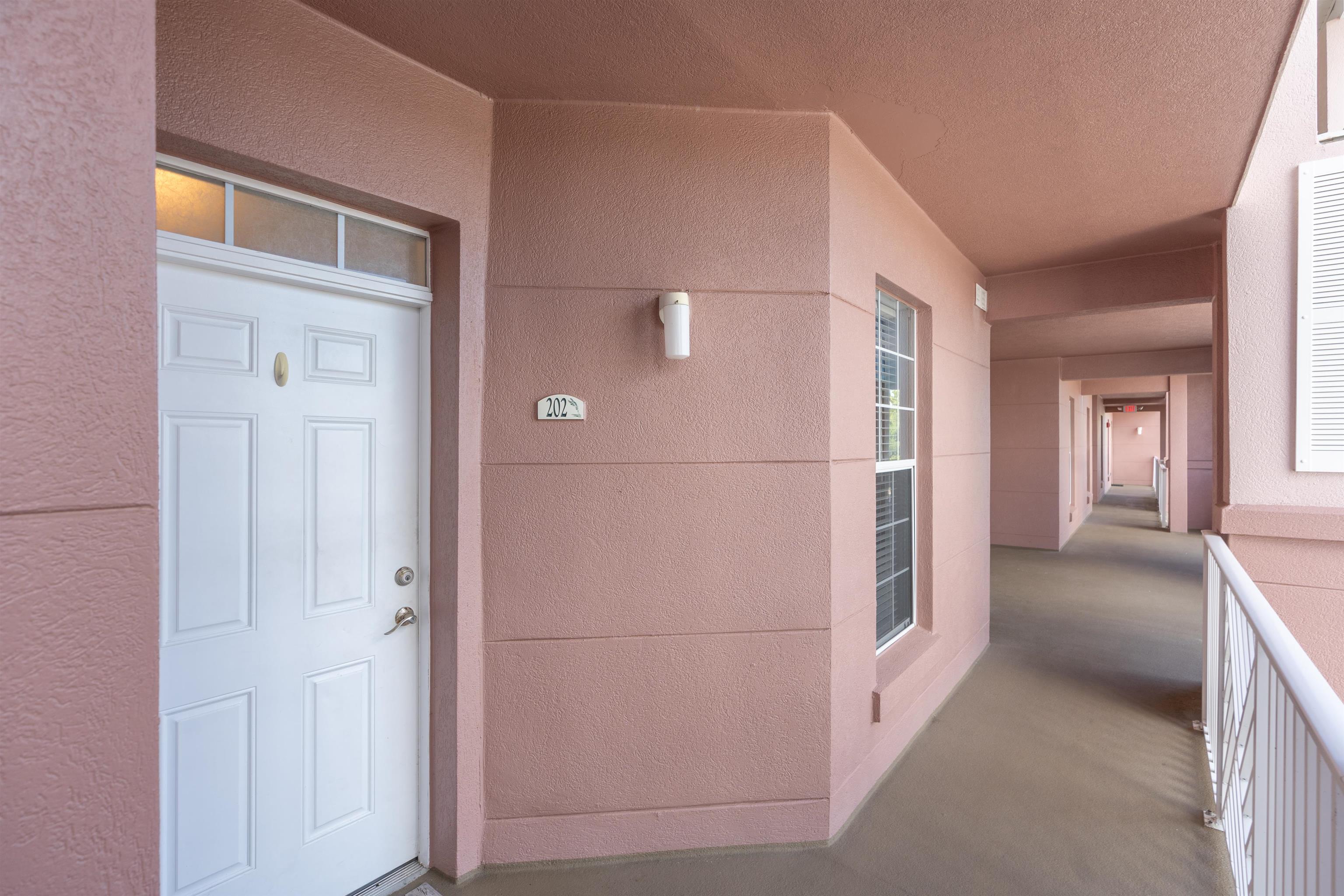 255 Atlantis Circle, Unit D202 St. Augustine Beach, FL 32080 - Photo 6 of 45 a view of a hallway with staircase
