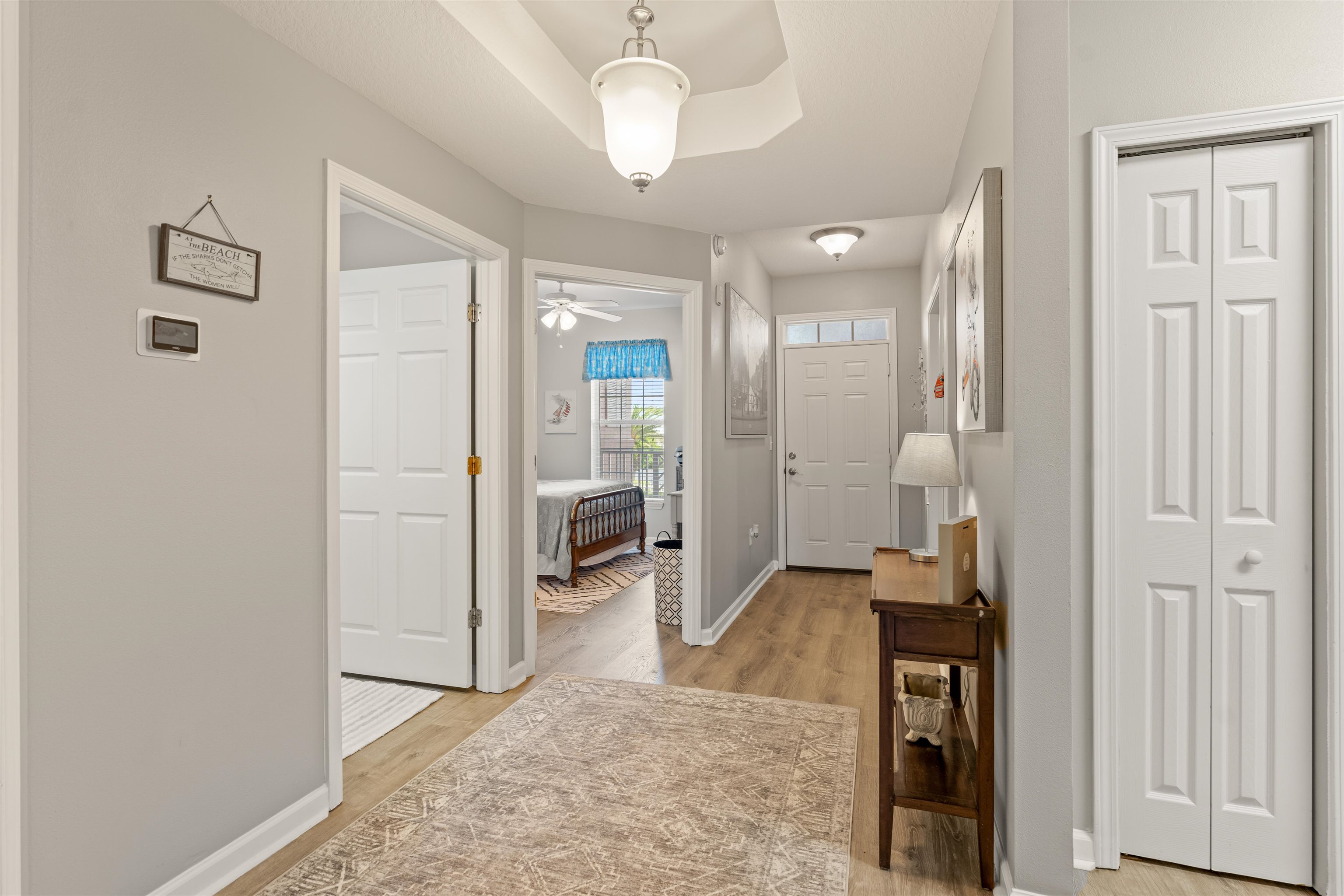255 Atlantis Circle, Unit D202 St. Augustine Beach, FL 32080 - Photo 7 of 45 a view of a hallway with a livingroom and a chandelier
