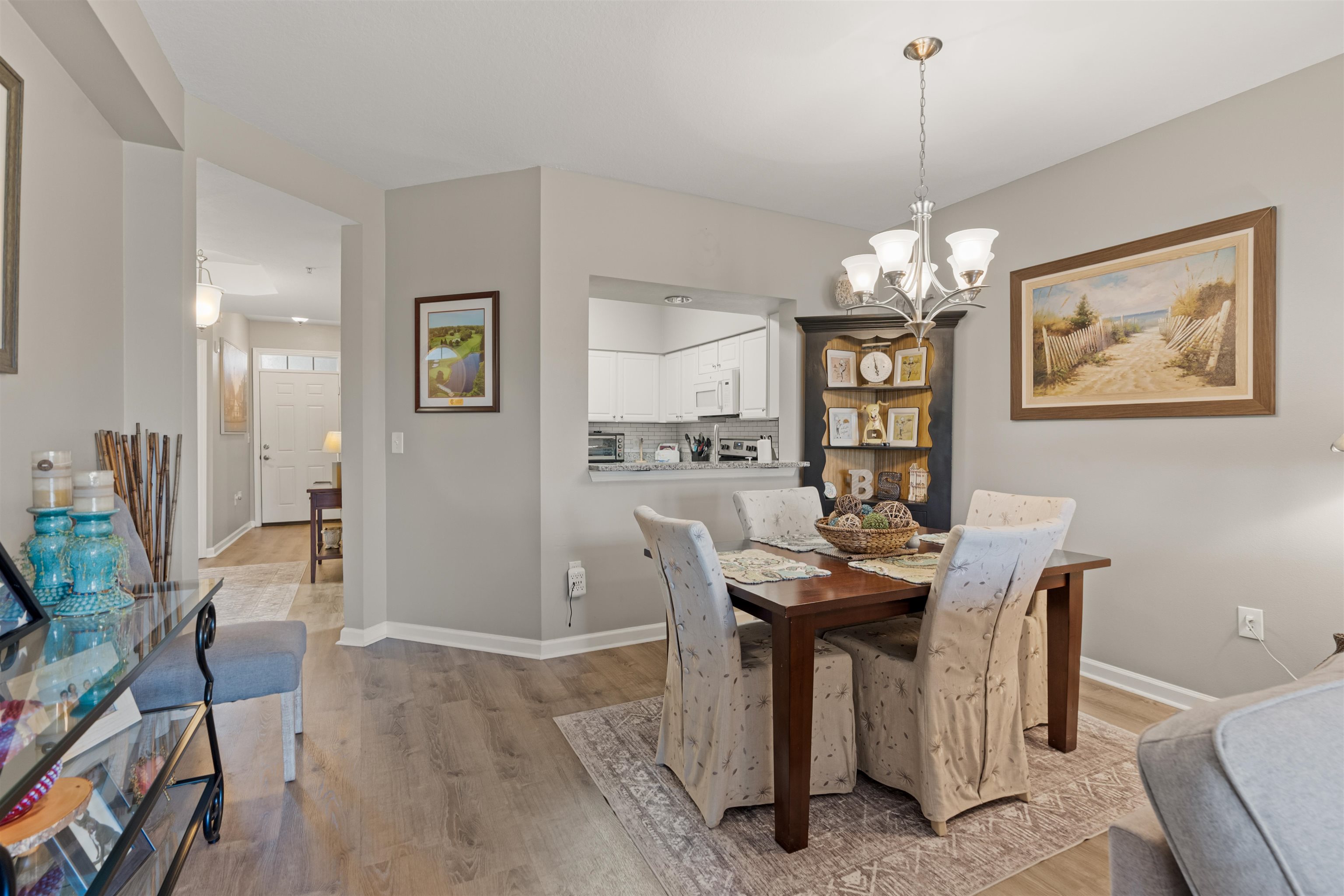 255 Atlantis Circle, Unit D202 St. Augustine Beach, FL 32080 - Photo 8 of 45 a view of a dining room with furniture and chandelier