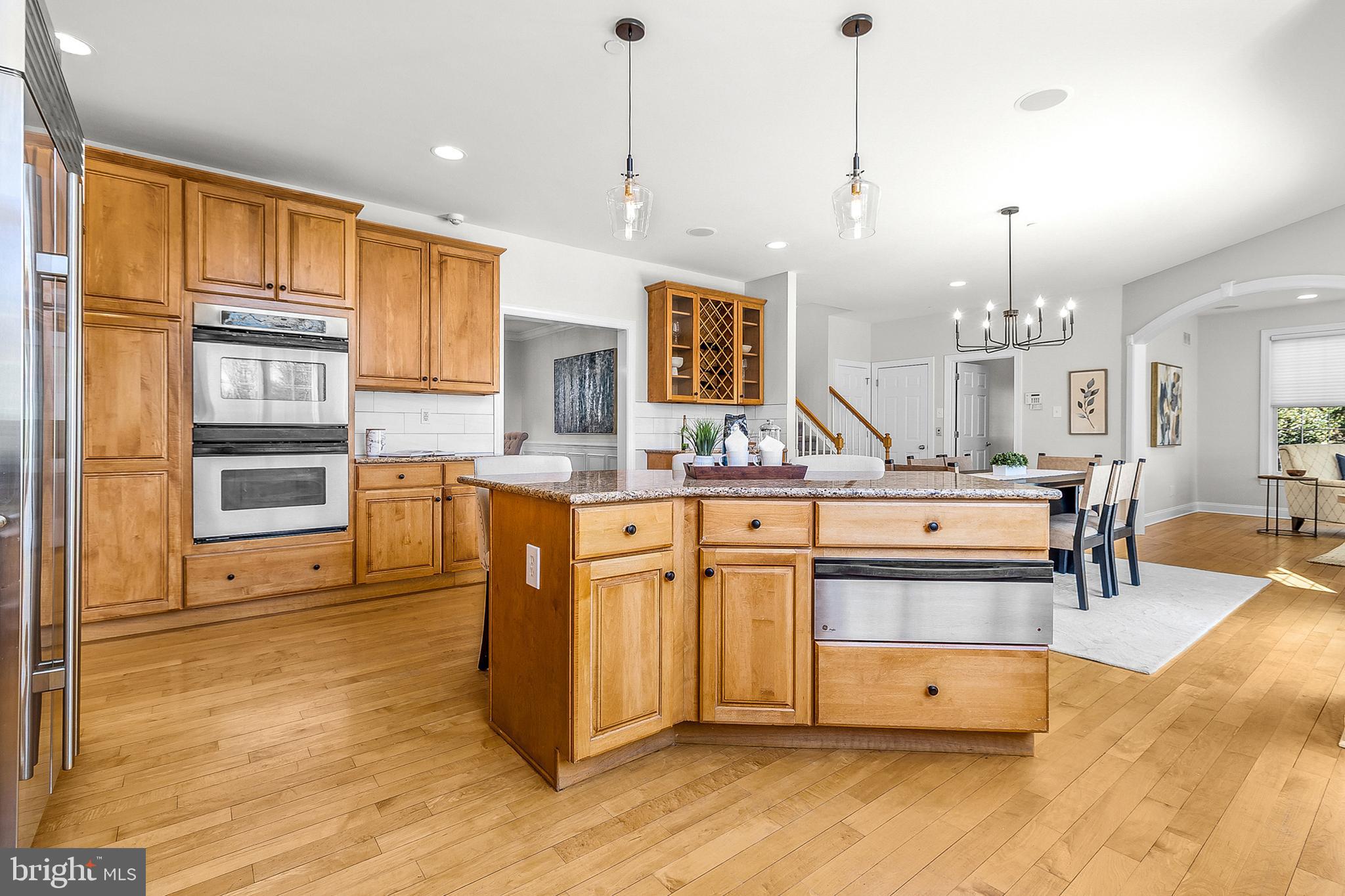 4 Greystone Circle Newtown Square, PA 19073 - Photo 13 of 51 a large kitchen with kitchen island a stove a sink cabinets and wooden floor