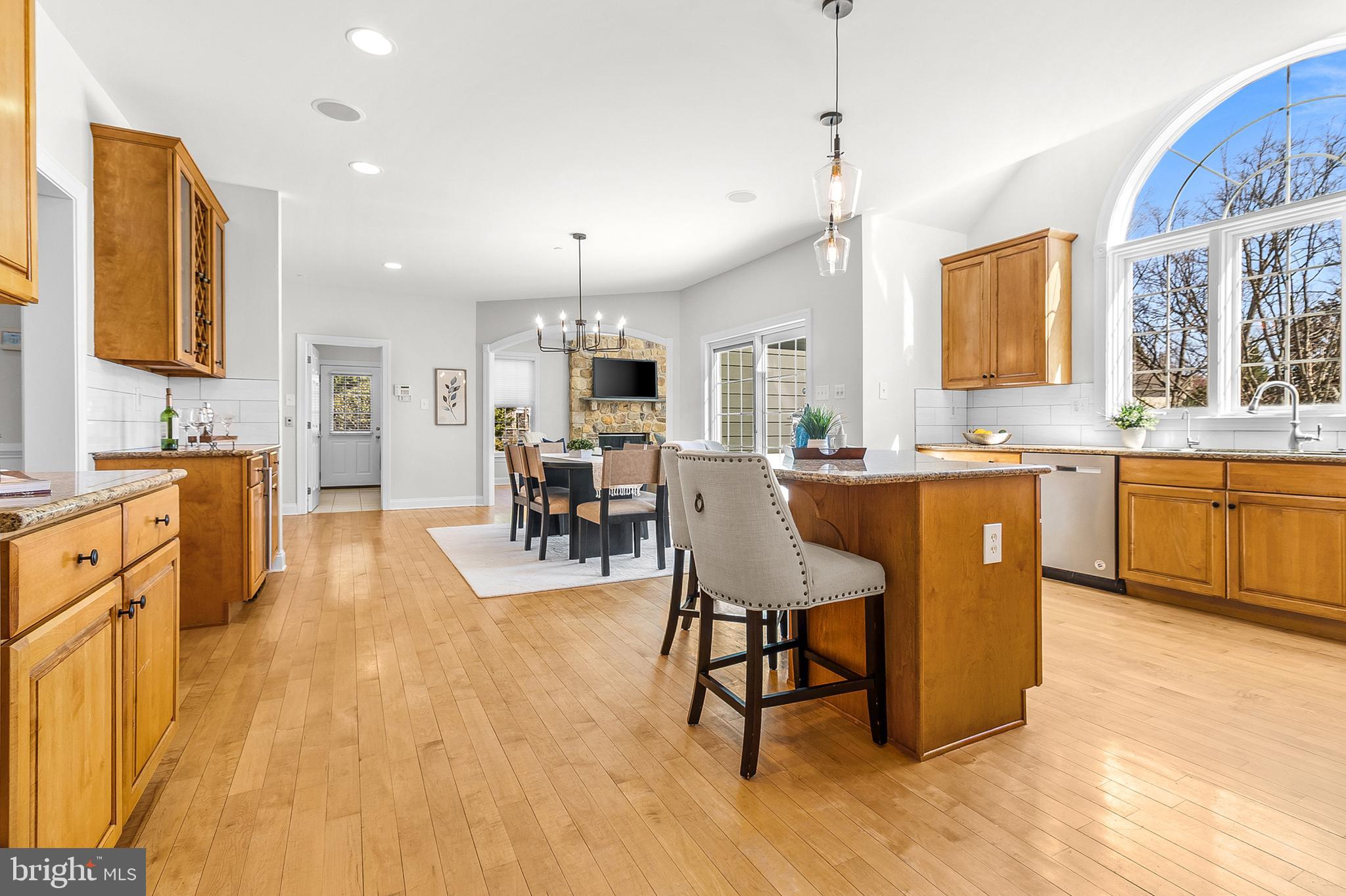 4 Greystone Circle Newtown Square, PA 19073 - Photo 10 of 51 a dining hall with stainless steel appliances granite countertop a sink a stove a dining table and chairs with wooden floor