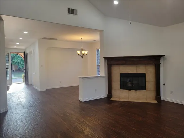 a view of an empty room and wooden floor