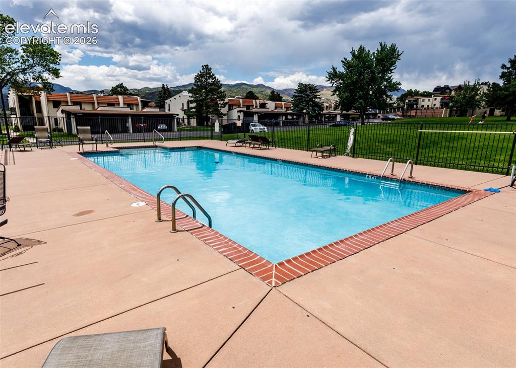 1034 Fontmore Road, Unit D Colorado Springs, CO 80904 - Photo 36 of 43 a view of a swimming pool with a lawn chairs