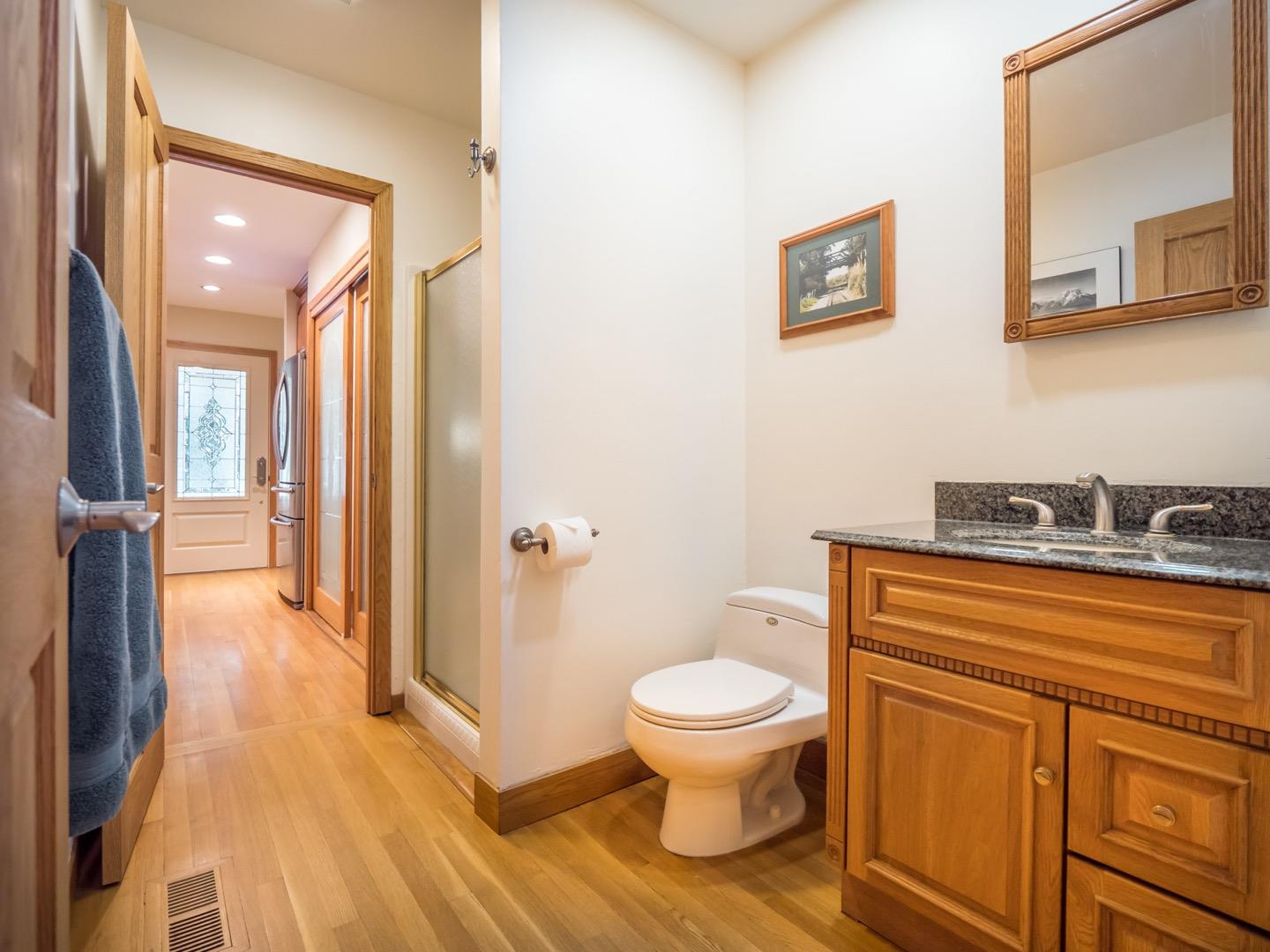 18635 Favre Ridge Road Los Gatos, CA 95033 - Photo 13 of 74 a bathroom with a granite countertop toilet sink and mirror