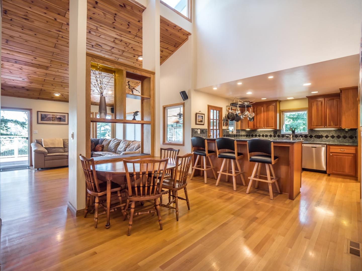 18635 Favre Ridge Road Los Gatos, CA 95033 - Photo 14 of 74 a view of a dining room with furniture wooden floor and kitchen view
