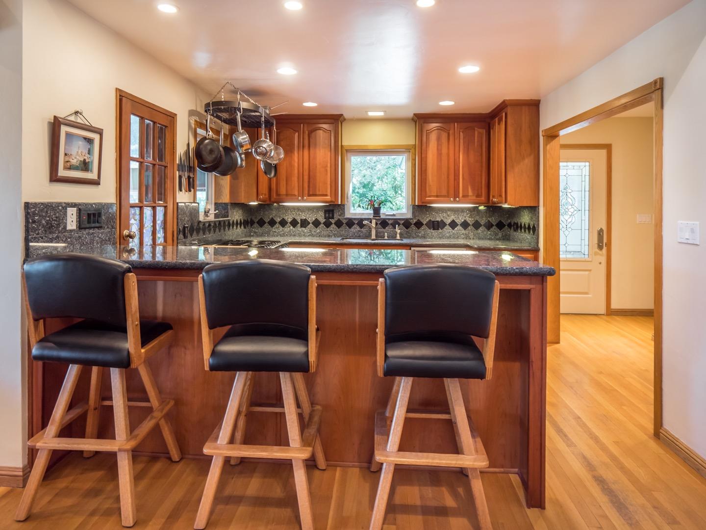 18635 Favre Ridge Road Los Gatos, CA 95033 - Photo 15 of 74 a kitchen with stainless steel appliances granite countertop a stove top oven a sink dishwasher and white cabinets next to a window