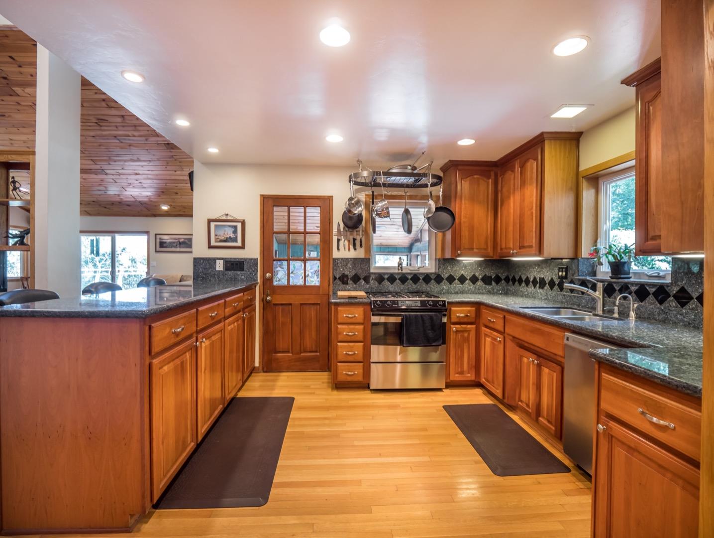 18635 Favre Ridge Road Los Gatos, CA 95033 - Photo 16 of 74 a large kitchen with stainless steel appliances kitchen island granite countertop a large counter top cabinets and furniture