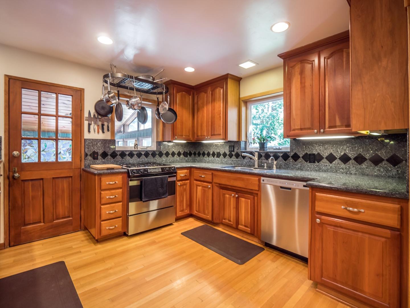 18635 Favre Ridge Road Los Gatos, CA 95033 - Photo 17 of 74 a kitchen with stainless steel appliances granite countertop a stove a sink and a refrigerator