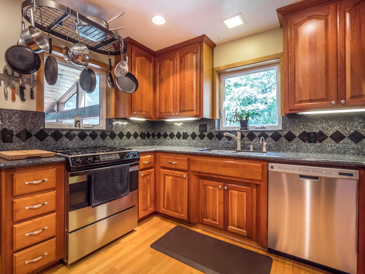 18635 Favre Ridge Road Los Gatos, CA 95033 - Photo 18 of 74 a kitchen with stainless steel appliances a stove a sink and a microwave