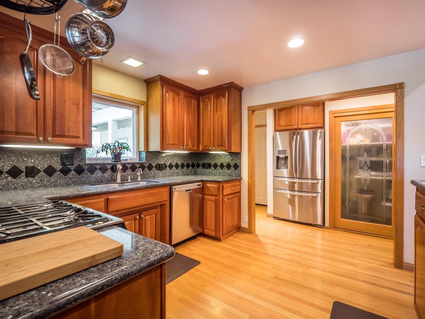 18635 Favre Ridge Road Los Gatos, CA 95033 - Photo 19 of 74 a kitchen with stainless steel appliances granite countertop a stove a sink and a refrigerator