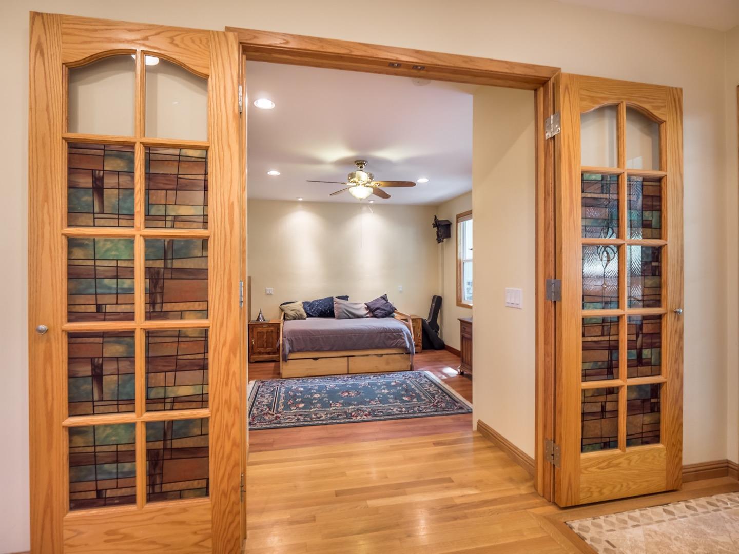 18635 Favre Ridge Road Los Gatos, CA 95033 - Photo 8 of 74 a view of a bedroom with a balcony and a ceiling fan