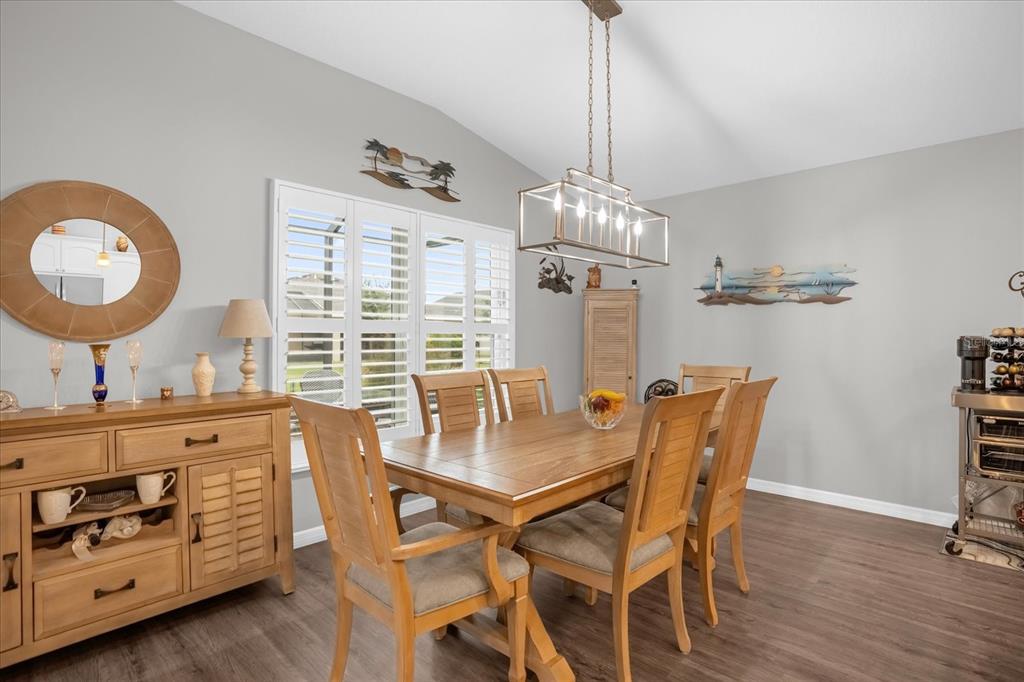 3782 Arlington Ridge Boulevard Leesburg, FL 34748 - Photo 12 of 52 a view of a dining room with furniture and wooden floor