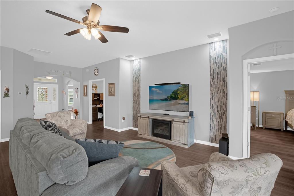 3782 Arlington Ridge Boulevard Leesburg, FL 34748 - Photo 6 of 52 a living room with furniture a fireplace and a flat screen tv