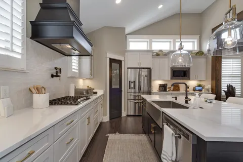 a kitchen with stainless steel appliances granite countertop a sink stove and refrigerator