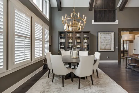 a view of a dining room with furniture a chandelier and wooden floor