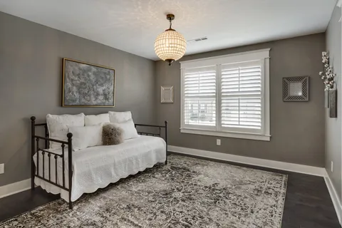 a view of a livingroom with wooden floor and a large window